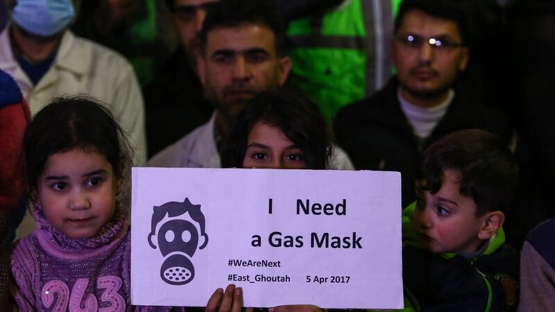 Syrian children, alongside first aiders and civil defence volunteers, at a gathering to show solidarity with victims in Douma, Syria. Photograph: Mohammed Badra/EPA