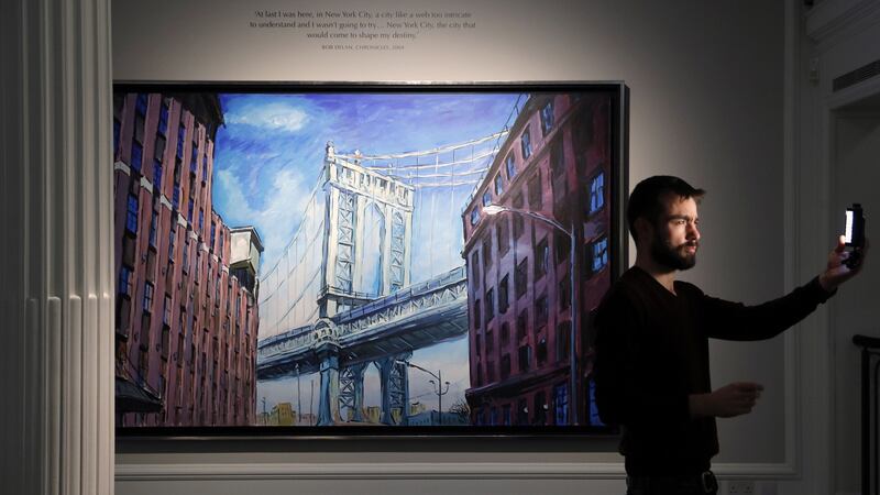 A cameraman  tests the  light in front of Bob Dylan’s painting Manhattan Bridge, Downtown New York at the Halcyon Gallery in London during a preview of his artwork this month. Photograph: Adrian Dennis/AFP/Getty Images