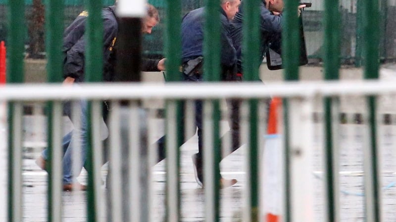 Armed Gardai approach a security cash in transit van in the cargo area of Dublin Airport during a tiger kidnapping. Photograph: Colin Keegan, Collins Dublin.