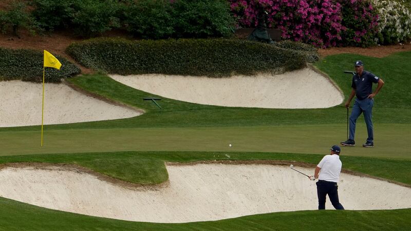 Shane Lowry hits out of a bunker on the 12th. Photo: David J. Phillip/AP Photo