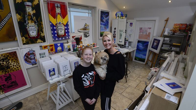 Artist Orla Walsh with her daughter and the family dog  at her studio in Foxrock. Photograph: Cyril Byrne