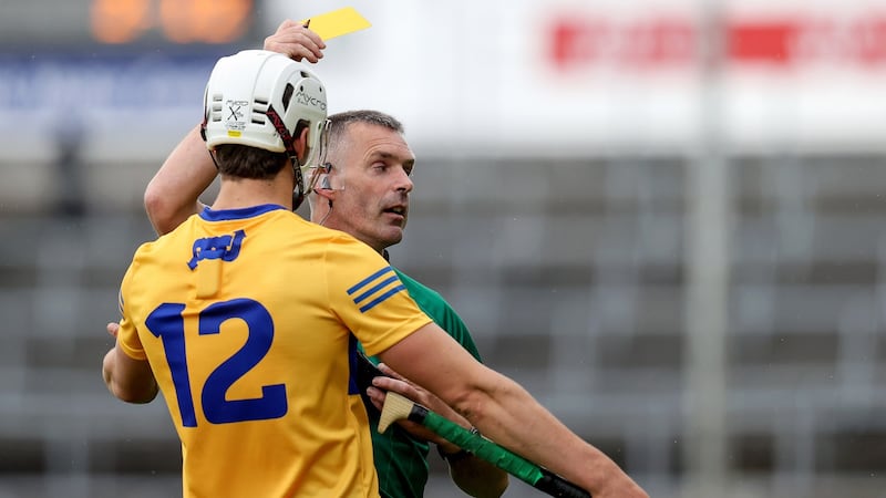 Referee James Owens shows Aidan McCarthy a yellow card. Photo: Bryan Keane/Inpho