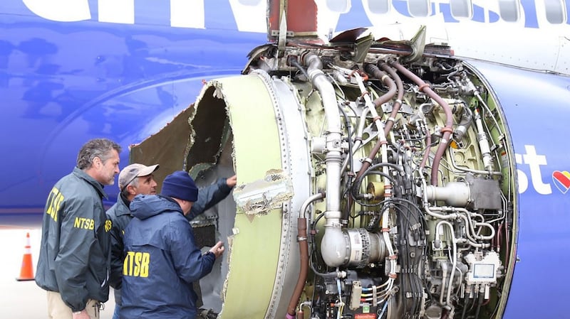 Investigators examine damage to the engine of the Southwest Airlines plane. Photograph: AFP Photo/National Transportation Safety Board