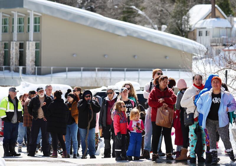 Residents wait in line to receive donated food outside the local grocery store, which was severely damaged when its roof collapsed under the weight of several metres of snow, after a series of winter storms in the San Bernardino Mountains in southern California on March 3rd in Crestline, California. Some residents have been trapped in Crestline for days due to heavy snowfall while the grocery store was the main hub for food purchases in town. Photograph: Mario Tama/Getty