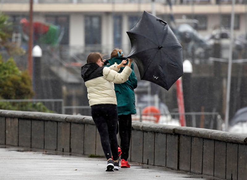 Walkers battle the heavy rain and wind in Howth  as Storn Agnes hits this afternoon. Photograph: Colin Keegan/Collins Dublin