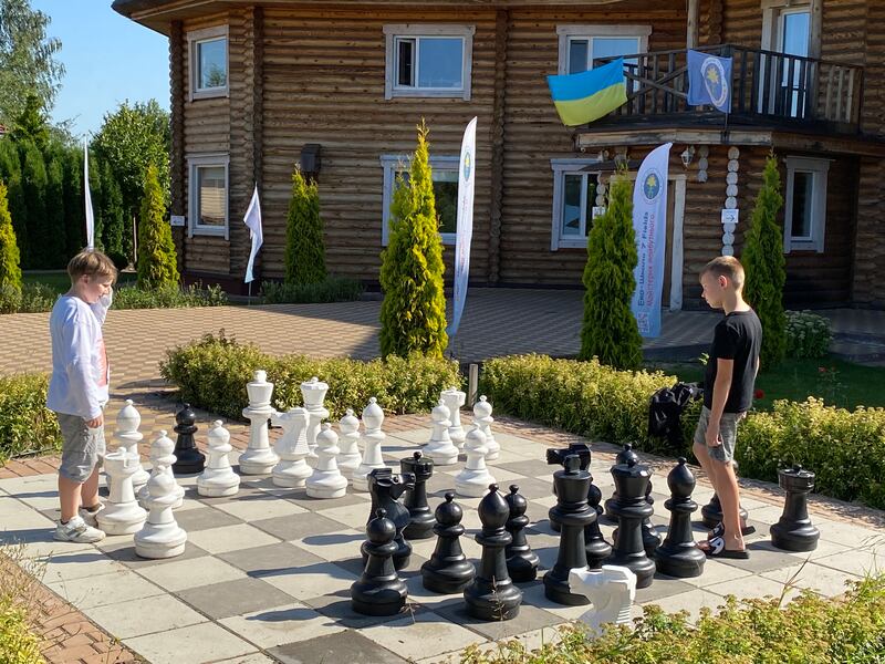 Playing oversized chess at the 7 Fields summer camp for Ukrainian children affected by the war. Photograph: Lara Marlowe