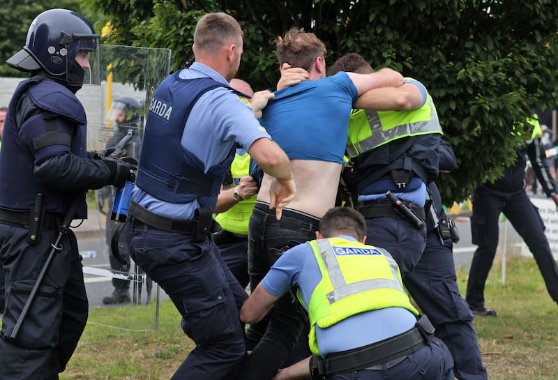 A protestor tussles with gardaí on the Malahide Road, Coolock, where a protest at the former Crown Paints factory turned violent. Photograph: Colin Keegan/Collins Dublin