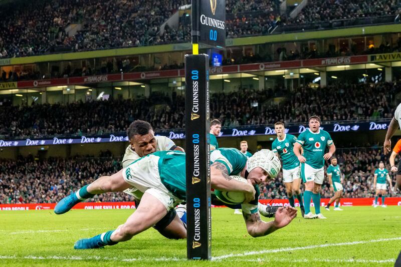 Mack Hansen scores a try despite Fiji's Elia Canakaivata. Photograph: /Dan Sheridan/Inpho