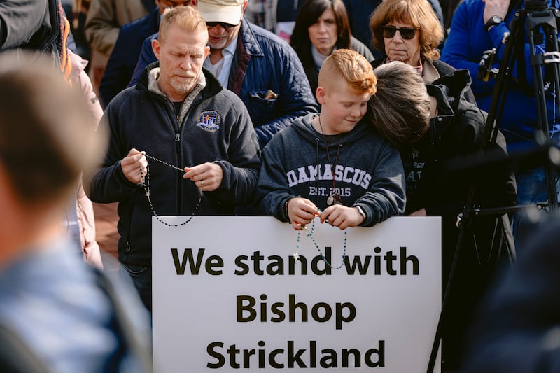 Tim, Luke and Tina McMorland listen to Bishop Joseph Strickland during a rally outside the United States Conference of Catholic Bishops  in Baltimore on Wednesday. Photograph: Wesley Lapointe/New York Times
                      