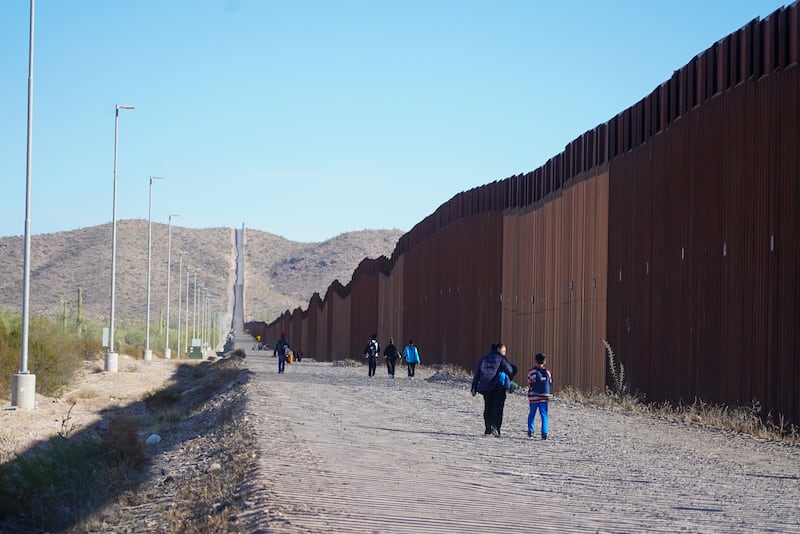 Unauthorised immigrants walk along the the US and Mexico border after crossing into the American side with the help of a Mexican cartel. Photograph: Enda O'Dowd