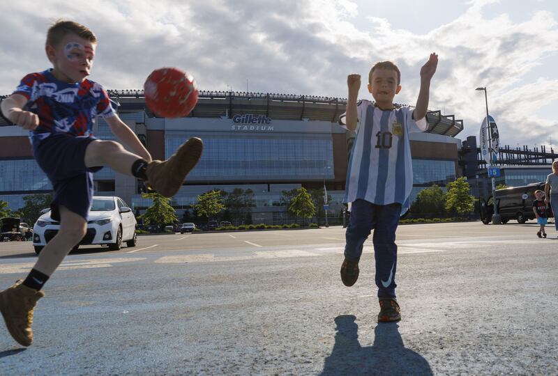 A boys plays soccer in the lot while wearing a Messi jersey before the start of the match between the New England Revolution and the Inter Miami at Gillette Stadium in Foxborough, Massachusetts, USA, on June 10th, 2023. Photograph: Shutterstock