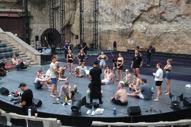 Darcy Grant (centre) speaking with acrobats ahead of their first performance of The Pulse in Barcelona, at the Teatre Grec. Photograph: Conor Capplis