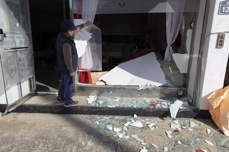 A resident beside her damaged house at the site of an accidental fighter jet bombing in Pocheon, South Korea. Photograph: Jeon Heon-Kyun/EPA