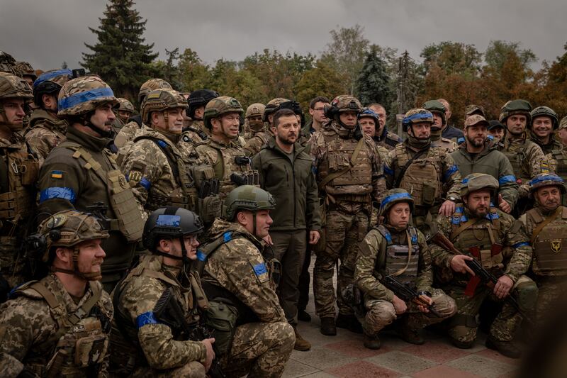 President Volodymyr Zelenskyy makes an unannounced visit to a flag-raising ceremony in the main square of the recaptured city of Izyum. Photograph: Nicole Tung/The New York Times