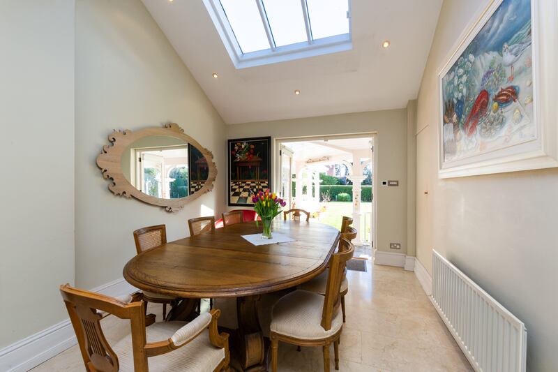 A diningroom looks out onto the veranda and rear garden.