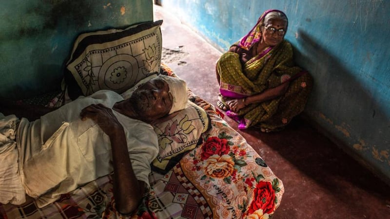 Calvin Klein Obsession:  Named Mukndro, a 72-year-old who was gravely injured by an elephant brought in to help catch the man-eating tiger, in bed at his home with his wife. Photograph: Bryan Denton/NYT