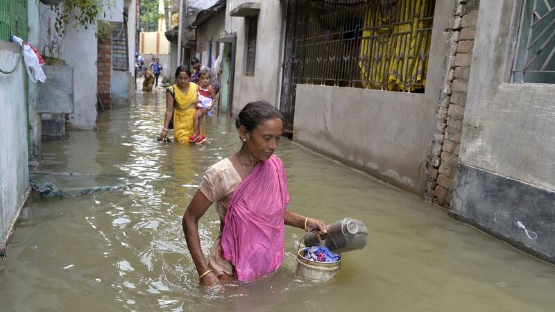 Indian residents walk through flood waters in Malda in the Indian state of West Bengal on August 24th. Photograph:  Diptendu Dutta/AFP/Getty Images