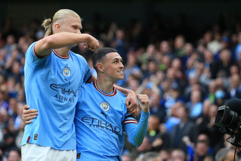 Phil Foden celebrates scoring his team's sixth goal and completing his hat-trick with Manchester City team-mate Erling Haaland. Photograph: Lindsey Parnaby/AFP via Getty Images