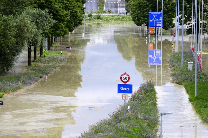 A flooded streeted in Sierre, Switzerland. Photograph: Jean-Christophe Bott/Keystone/AP