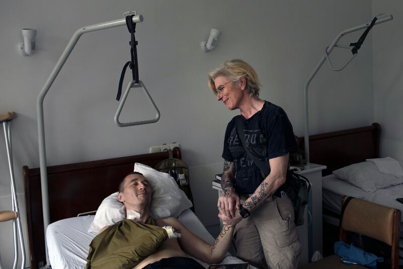 Yulia Paievska, a Ukrainian volunteer medic who was held captive by the Russian military, visits her friend Yuriy Hudymenko, a wounded Ukrainian soldier, at the hospital in Kyiv where she has been recovering. Photograph: Emile Ducke/The New York Times