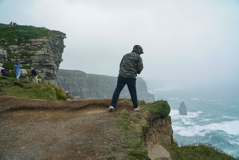 Tourists over look the Cliffs of Moher in Clare where concerns were raised about safety earlier in the year after a young woman died after losing her footing and falling from the cliffs. Photograph: Enda O'Dowd