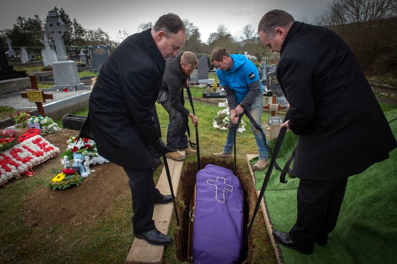 The casket of Yevhen Mishchenko is lowered into his plot. Photograph: Michael Mac Sweeney/Provision