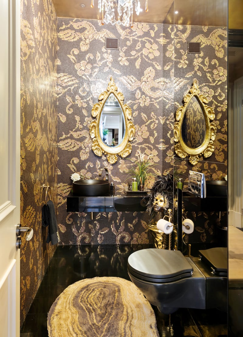 Black-and-gold mosaic-tiled toilet