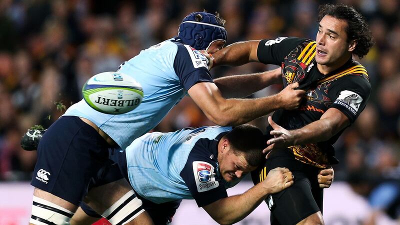 James Lowe of the Chiefs offloads in the tackle against Waratahs’ Tom Robertson and Dean Mumm at Waikato Stadium  in Hamilton, New Zealand. Photograph:  Hagen Hopkins/Getty Images