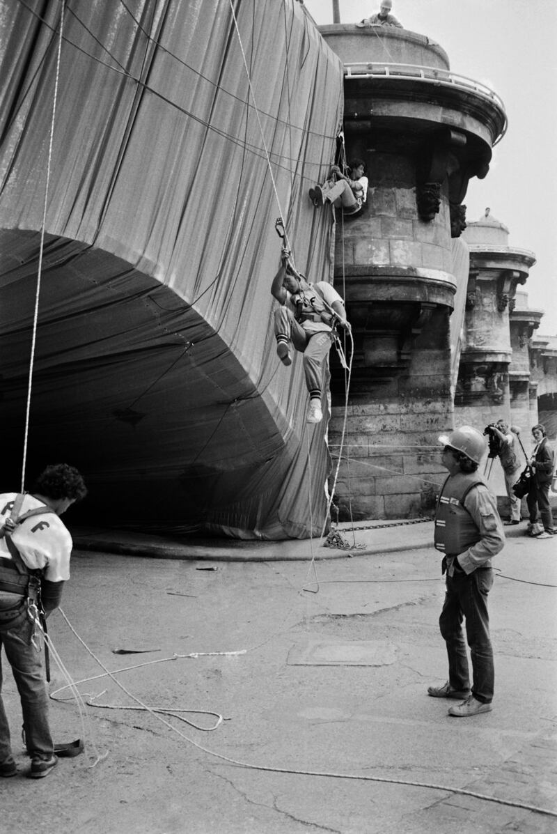 Christo and Jeanne-Claude: the artist watch Pont Neuf, in Paris, being wrapped in 1985. Photograph: Pierre Guillaud/AFP via Getty