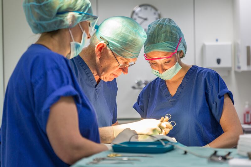 Dr Maurice Collins of Hair Restoration Blackrock (centre) performing hair restoration surgery. Photograph: Hair Restoration Blackrock