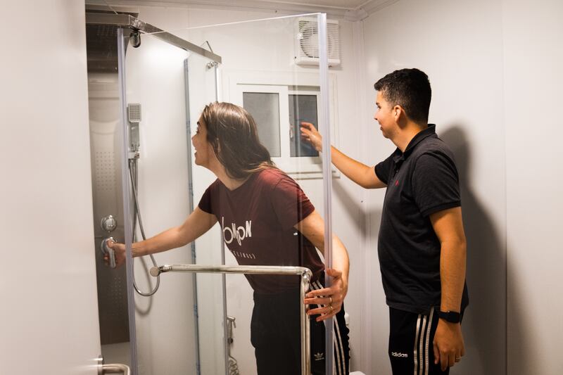 Gihana Fava and Renan Almeida as they find the hot water working in their rented room. Photograph: Erin Schaff/The New York Times