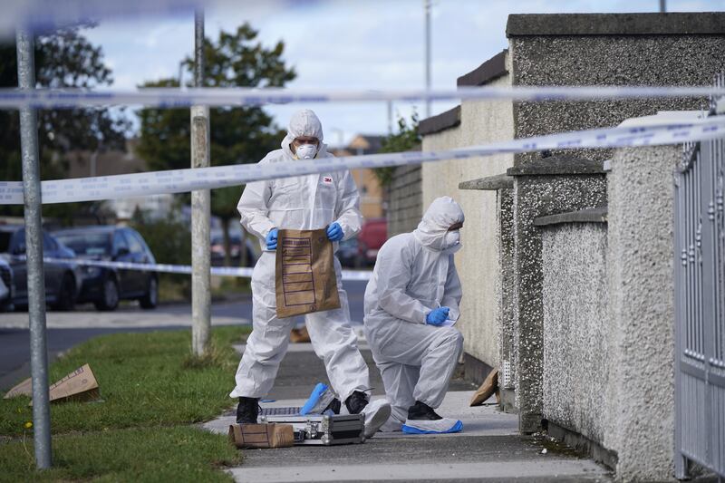 Forensic officers remove items from the scene in the Rossfield Estate in Tallaght, Dublin. Photograph: Niall Carson/PA