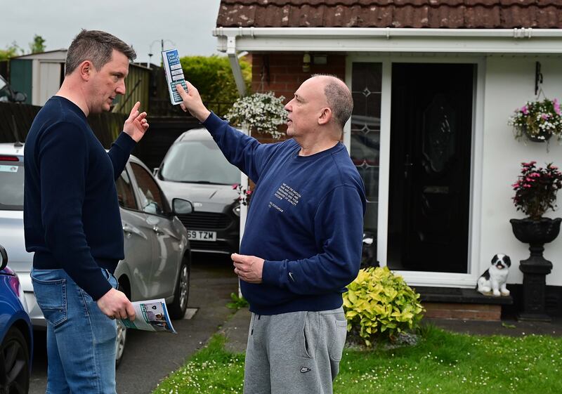 John Finucane in the Hollybrook estate, Glengormley, North Belfast, in conversation with voter Harry Gibson. Photograph: Arthur Allison/Pacemaker