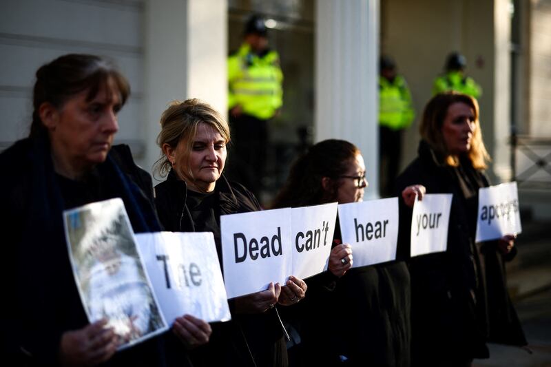 Protesters hold placards duing a gathering outside the UK Covid-19 Inquiry building in west London on December 6th as Britain's former prime minister Boris Johnson gave evidence regarding his management of the pandemic. Photograph: Henry Nicholls/AFP