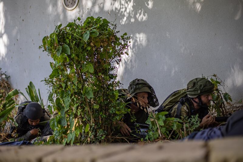 Israeli soldiers take cover on a street in Sderot, southern Israel. An invasion of Gaza is imminent. Photograph: Martin Divisek/EPA/EFE