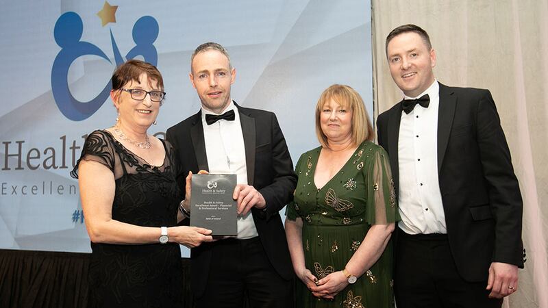 Patricia Ennis Gillen, awards judge, presents the Health & Safety Excellence Award - Financial & Professional Services to the Bank of Ireland team