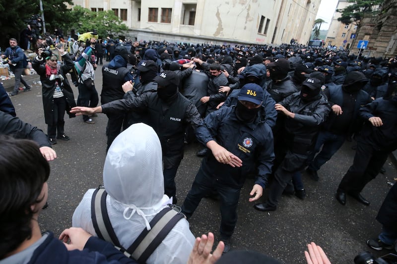 Police block demonstrators near the parliament building in Tbilisi. Photograph: Zurab Tsertsvadze/AP