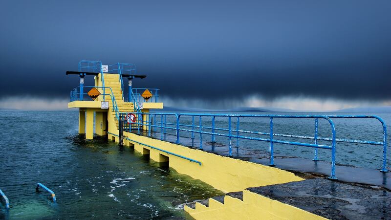 Travel Ireland May 2019. Rain clouds sweeping over galway bay towards the clare coastline. Blackrock Diving Tower, Galway. Photograph: Michelle McMahon/Moment/Getty