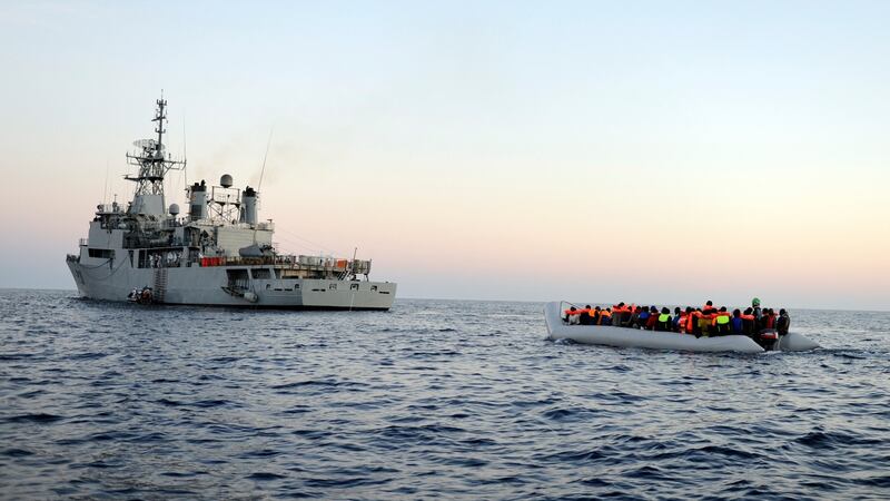 A migrant boat being piloted by the Naval Service prepares to be brought alongside the LÉ Eithne in June 2015. File photograph: Able Seaman David Jones/Defence Forces