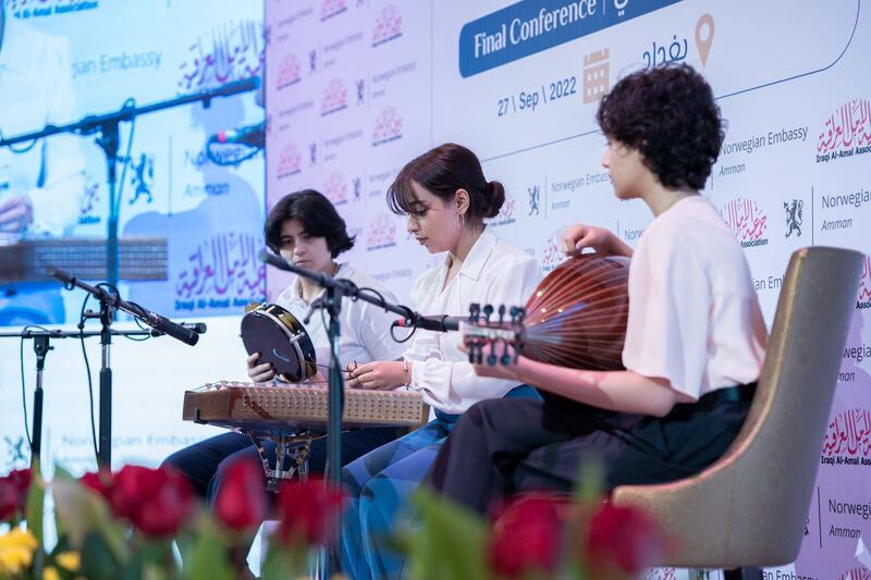 Qamar Alani (centre) playing the santur, with other musicians. Photograph: Courtesy of Qamar Alani