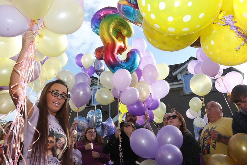 Jolene Morey, sister of Nicole Morey, releasing balloons in memory of the deceased woman during a vigil at her mother's home in Co Limerick last Thursday. Photograph: Brendan Gleeson