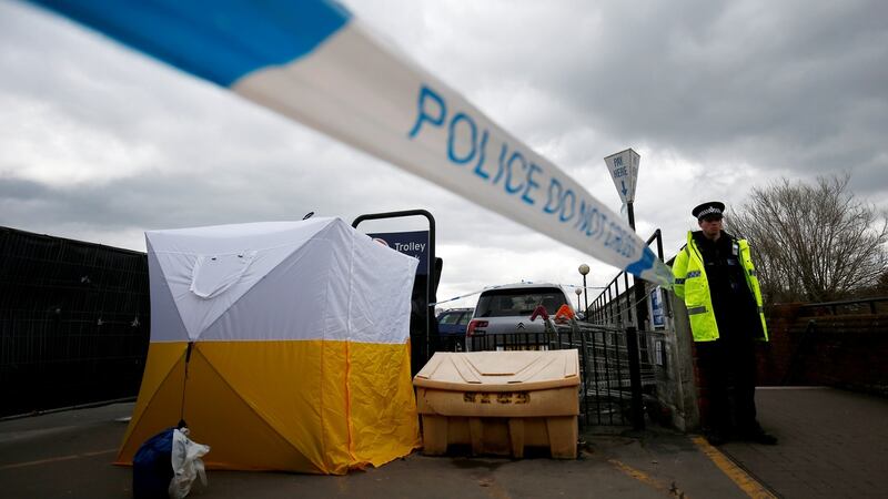 A police officer stands at a cordon placed around a payment machine covered by a tent in a supermarket car park near to where former Russian intelligence agent Sergei Skripal and his daughter Yulia were found poisoned in Salisbury, Britain, March 13, 2018. REUTERS/Henry Nicholls