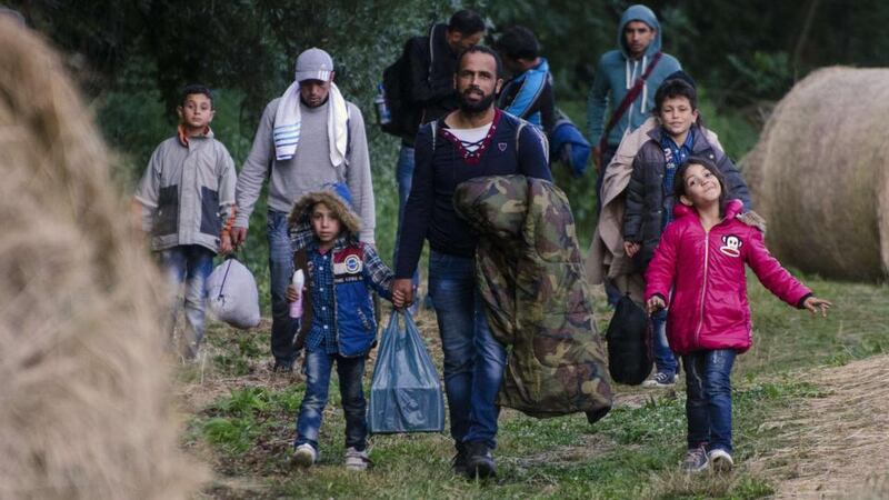 Migrants at the  border between Hungary and Serbia. Hungary says it is building a four-metre high fence to keep out migrants. Photograph: Csaba Segesvari/AFP/Getty Images