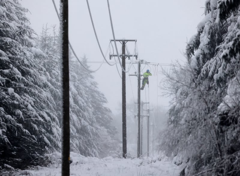 An ESB repair crew fix a broken power line due to a fallen tree in the hills close to Castlewarren near Kilkenny City. Photograph: Alan Betson/The Irish Times

