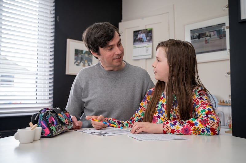 Brian with eldest daughter Sadie Rose mapping out financial goals in the kitchen