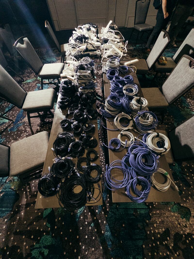 A table in the AI Village at the annual Defcon conference in Las Vegas. Photograph: Mikayla Whitmore/The New York Times
                      