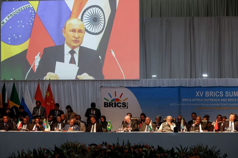 A screen shows Russian president Vladimir Putin virtually delivering remarks at a meeting during the 2023 Brics Summit at the Sandton Convention Centre in Johannesburg on Thursday. Photograph: Marco Longari/AFP/Getty 