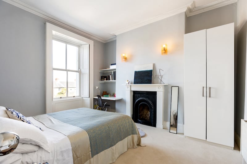 The main bedroom overlooks the back garden and has a Victorian fireplace and a fitted desk unit for handy working from home. 