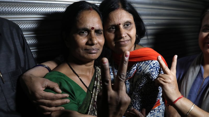 The mother (left) of the 2012 murder and gang rape victim  after the hanging of the convicted attackers in New Delhi. Photograph: Rajat Gupta/EPA