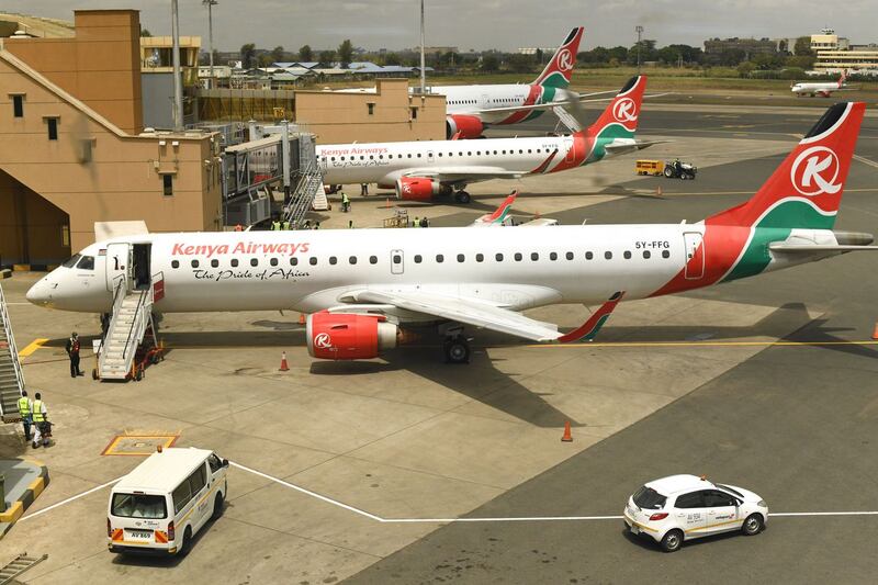 A picture taken through a window shows Kenya Airways planes parked at the parking bay at the Jomo Kenyatta international airport in Nairobi, on August 1, 2020, as Kenya Airways airline resumed flights to Britain after flights had been canceled during the COVID-19 (novel coronavirus) pandemic outbreak. (Photo by Simon MAINA / AFP) (Photo by SIMON MAINA/AFP via Getty Images)